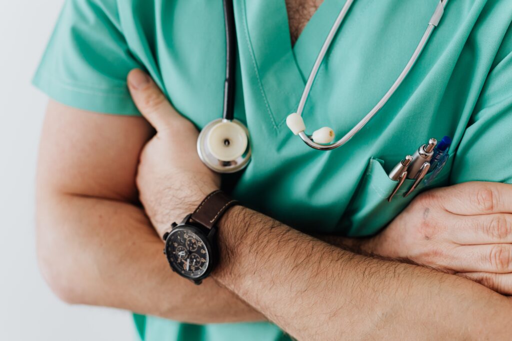 doctor in green scrubs with a stethoscope