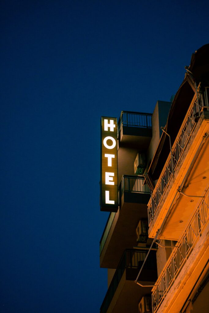 hotel sign glowing at night on building exterior